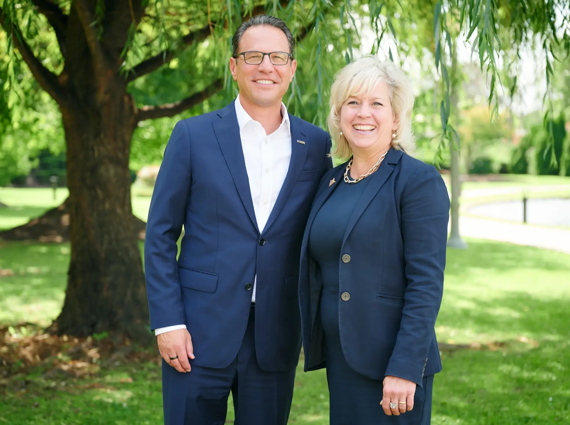 Elizabeth Moro and Pennsylvania Governor Josh Shapiro standing in a lawn at the Moro-Shapiro endorsement event.